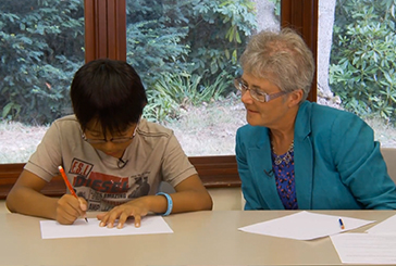 adult woman helping youth with papers