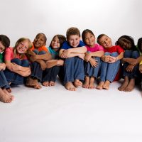 A diverse multi-ethnic group of children in colored shirts. African American, Asian, Indian, Caucasian.